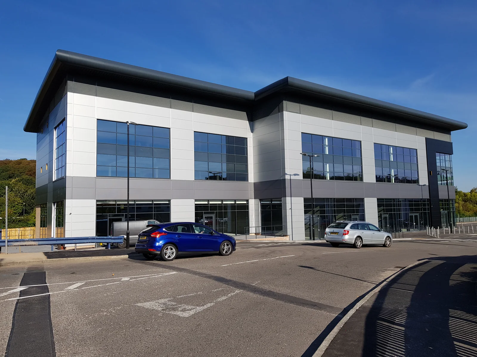 Glazed bays and entrance doors across the side elevation at Archer Road, Sheffield