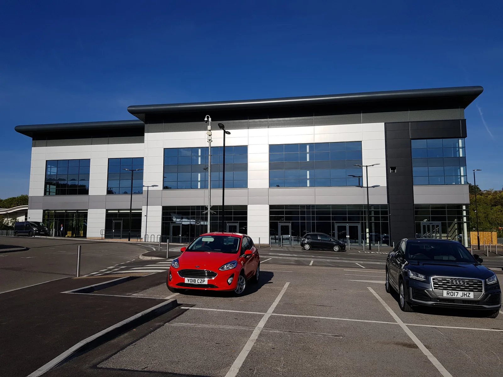 Ground-floor entrances and upper-floor glazing set into contrasting cladding at Archer Road, Sheffield